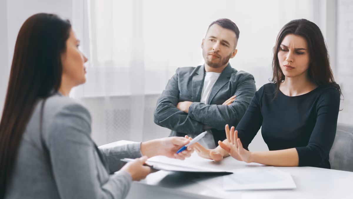 A frustrated couple in a meeting with a professional