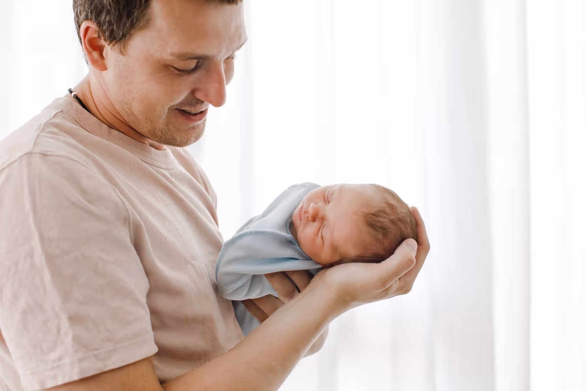 A father holding his newborn baby