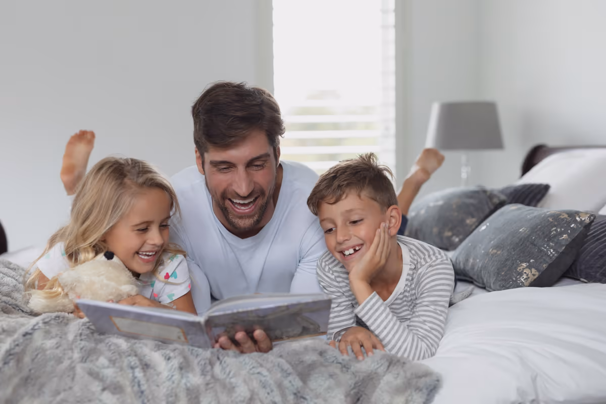 A father reading a book with his two children